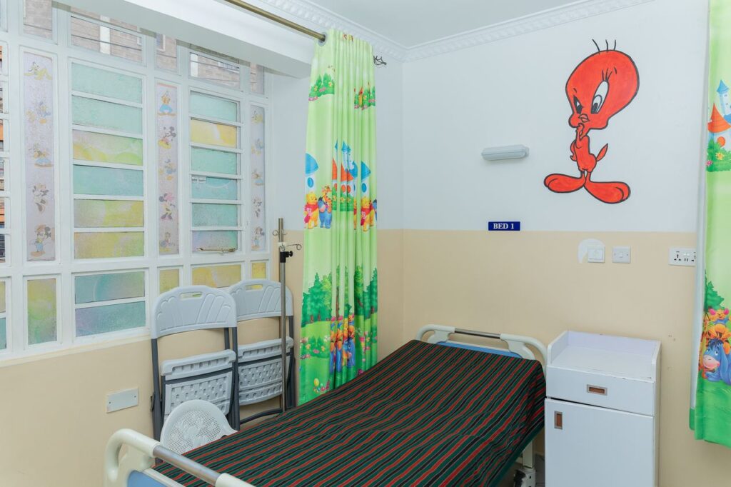Bright children's ward with cartoon curtains at Josma Health